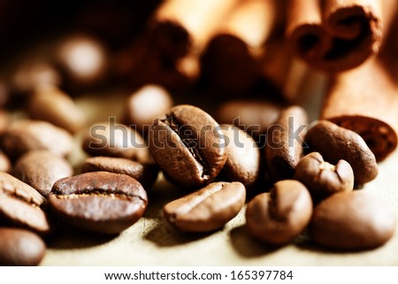 Close up of coffee beans with cinnamon sticks