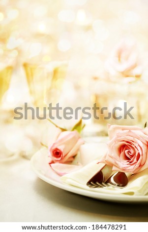 Decorated dinner table with beautiful pink roses