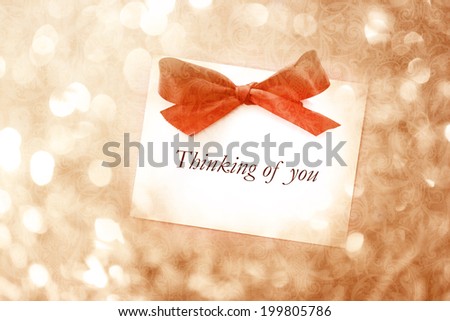 Thinking of you message with red ribbon on vintage light background
