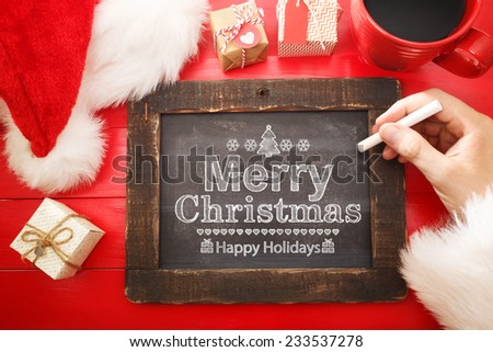 Merry Christmas text with a chalkboard on red table