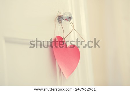 Hand crafted red heart hanging from door knob