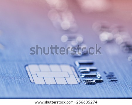 Low angle view of the microchip and raised numbers on a bank card with the expiry date below with shallow dof in a conceptual image