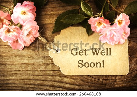 Get Well Soon message card with small roses on wood background