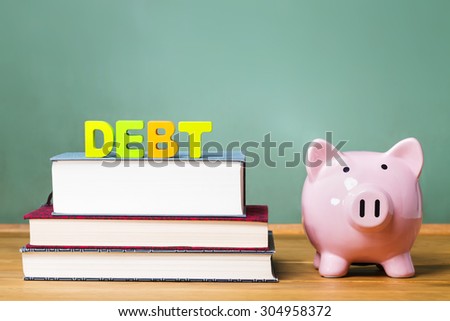 Education debt them with textbooks, piggy bank and chalkboard background