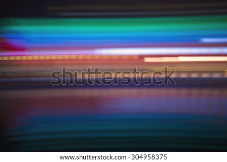 Abstract colorful horizontal streaked city lights backdrop