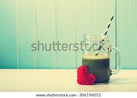 Green vegetable smoothie made with love in a masons jar