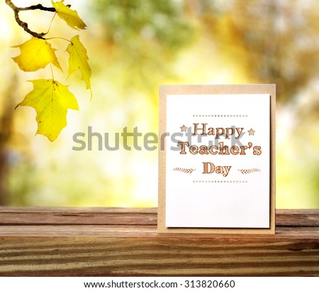 Happy Teachers Day greeting card on shinning fall background