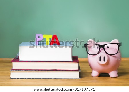 Parent Teacher Association theme with pink piggy bank with chalkboard in the background as concept image of the costs of education