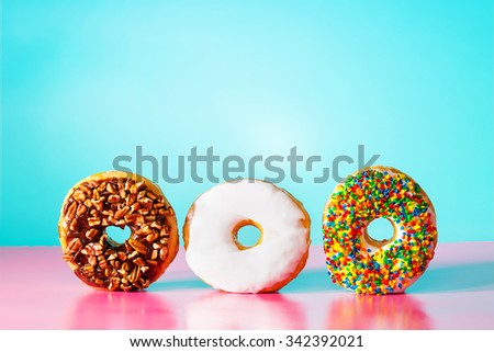Assorted donuts on pastel blue and pink background