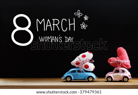 Womans Day message with pink and blue cars carrying heart cushions