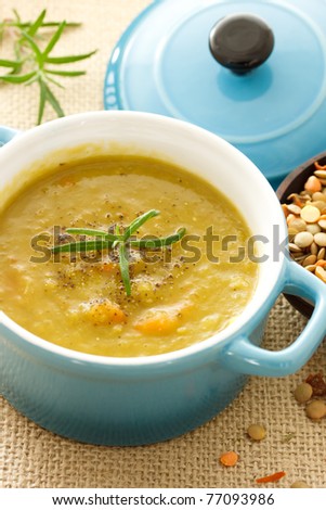 Lentil soup in blue pot with rosemary
