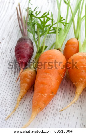 Organic garden carrots on white wood