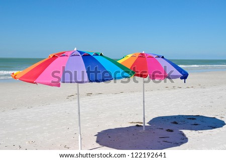 Two Brightly Colored Beach Umbrellas on the Beach