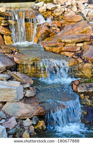 Water Cascading over Stone Waterfall Feature