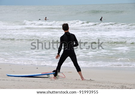ANNA MARIA ISLAND, FLORIDA-OCT. 20:Unidentified young male surfer warms up  before attempting to take on the unusually large waves in the Gulf of Mexico on Oct. 20, 2011 in Anna Maria Island