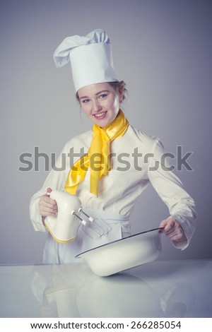 Photo of a smiling cook working with mixer