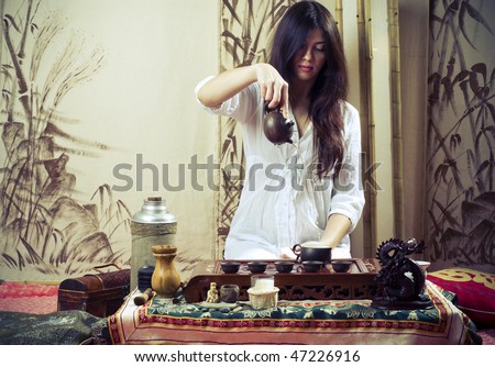 A young girl holds a Chinese tea ceremony