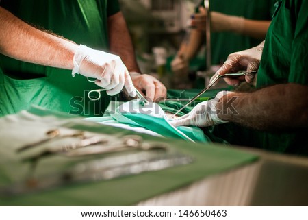 Doctors With Tools In Hands Making Surgery