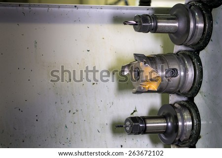 Rotating head with drilling machine bits and tools in a high precision mechanics plant at CNC lathe in workshop