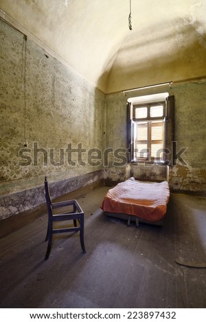 old abandoned room with bed and chair