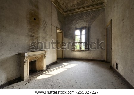 old abandoned room with window and fireplace
