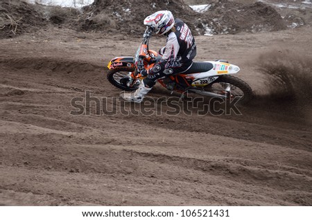 RUSSIA, SAMARA - APRIL 8: Motocross rider D. Vintaev, veering point-blank of sand with a large plume out from under the rear wheel, the Motocross practice April 8, 2012 in Samara, Russia