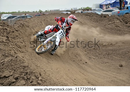RUSSIA, SAMARA - MAY 6: Motocross rider A. Shitikov veering point-blank of clay with a large plume out from under the rear wheel, the Regional Motocross Championship on May 6, 2012 in Samara, Russia