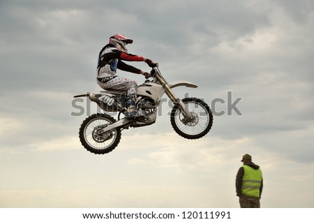 RUSSIA, SAMARA - MAY 6: The spectacular jump motocross racer A. Kravhuk on the background a stormy sky, the Open class the Regional Motocross Championship on May 6, 2012 in Samara, Russia