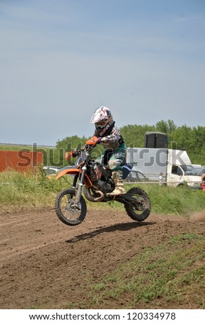 RUSSIA, SAMARA - JUNE 16: Unknown boy on a small motorcycle motocross jumps in descent, the 65 sm3 class Regional Motocross on June 16, 2012 in Samara, Russia