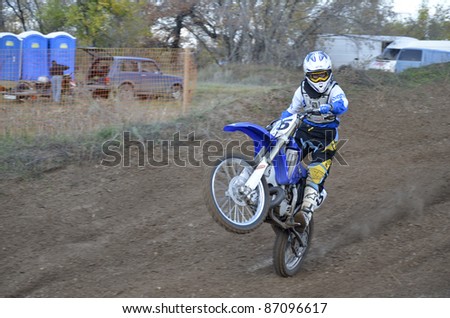 RUSSIA, SAMARA, CHAPAYEVSK - OCTOBER 17: V. Kulakov racer on a motorcycle rides on a the rear wheel the Open Cup \