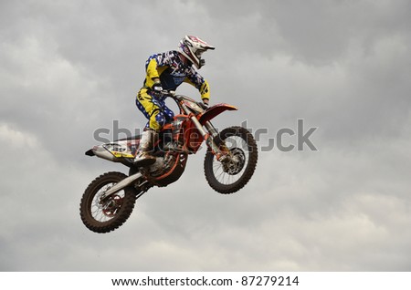 RUSSIA, SAMARA, CHAPAYEVSK - OCTOBER 17: The spectacular jump motocross racer D. Vintaev on the background a stormy sky the Open Cup \