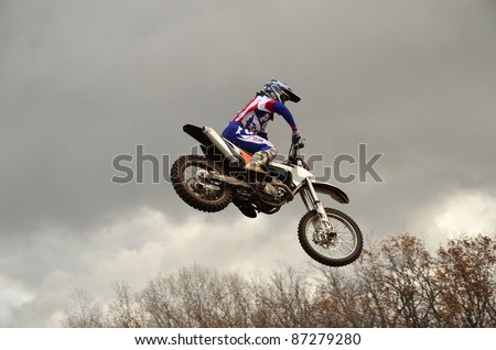 RUSSIA, SAMARA, CHAPAYEVSK - OCTOBER 17: Extreme jump moto racer A.Nikishkin on the background of clouds the Open Cup 
