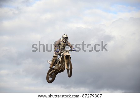 RUSSIA, SAMARA, CHAPAYEVSK - OCTOBER 17: Spectacular jump motocross racer A.Ivanyutin on the background a stormy sky the Open Cup \