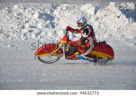 SAMARA, RUSSIA - JANUARY 29: a rider A. Utusikov on a motorcycle with spikes increases the speed at corner exit, Ice Speedway Cup of Russia January 29, 2012 in Samara, Russia