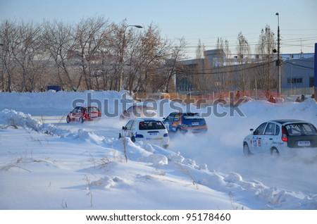 RUSSIA SAMARA - FEBRUARY 12: Group of cars compete in the first corner after the start, Cup of Russia in winter track motor racing February 12, 2012 in Samara, Russia