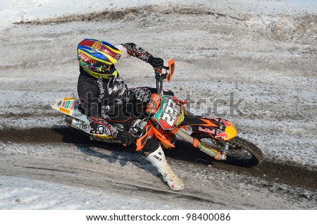 RUSSIA, SAMARA - MARCH 10: Rider D. Vintaev turns the with the slope of the motorcycle on snowy highway, shot from above, the Motocross workout March 10, 2012 in Samara, Russia