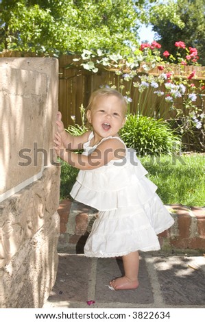 Baby Playing Peek A Boo In Garden