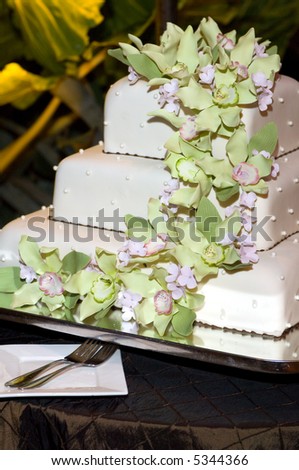 Beautiful Wedding Cake in front of Tropical Leaves