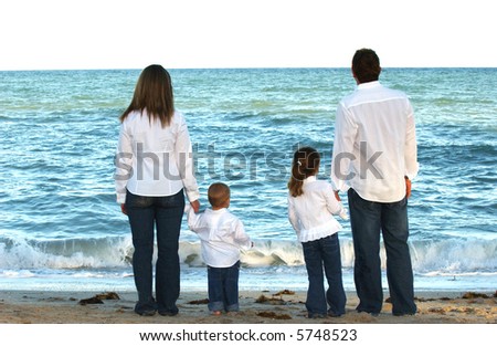 Family of Four Walking at the Beach