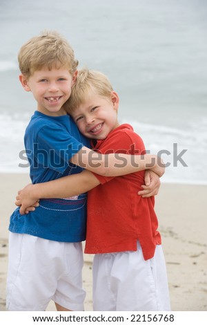 Two brothers hugging at the beach
