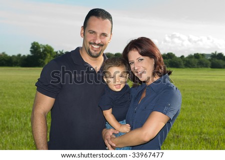 Happy Family at the Park Smiling at the Camera