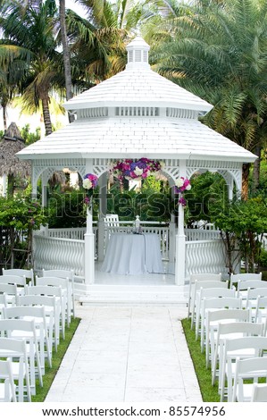 stock photo Beautiful white wedding gazebo with flower arrangements