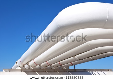 Industrial pipe with gas and oil and water on a background of blue sky