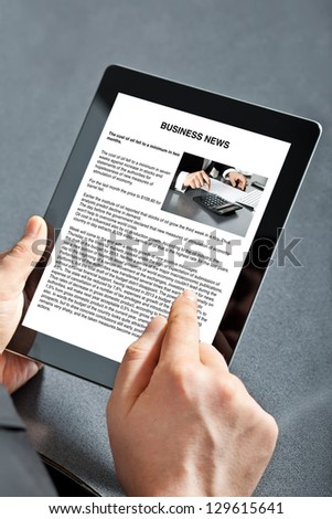 man holding tablet computer with business text on the screen man holding tablet computer with business text on the screen