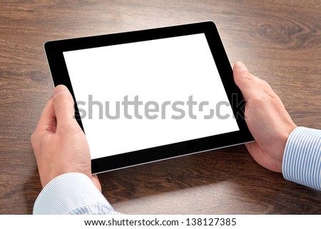 Businessman Holding A Tablet Computer With Isolated Screen Over The Villages Table