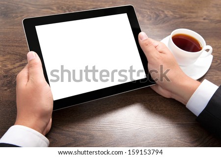 Businessman Holding A Tablet Computer With Isolated Screen Over The Villages Table