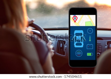 phone with interface auto alarm on a screen on a background woman driving a car