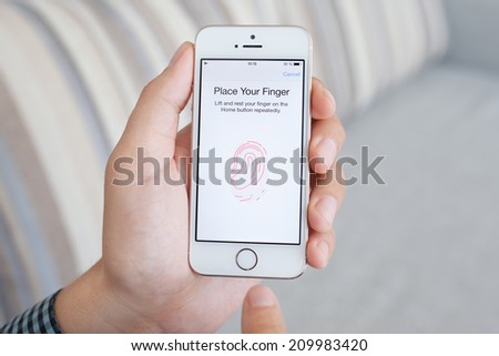 Simferopol, Russia - July 14, 2014: Touch ID the scanner of fingerprints developed by Apple corporation. Allows users to unblock the smartphone and to make purchases.