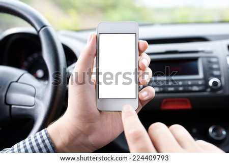driver sitting in the car and holding a touch phone with isolated screen