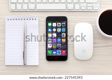 Alushta, Russia - October 25, 2014: New phone iPhone 6 Space Gray with apps on screen lies on the table. iPhone 6 was created and developed by the Apple inc.